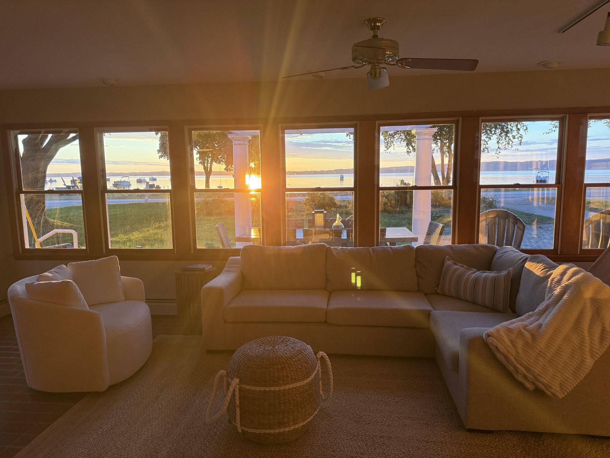 Sunrise light filling the sunroom at the lake villa, looking out over the water